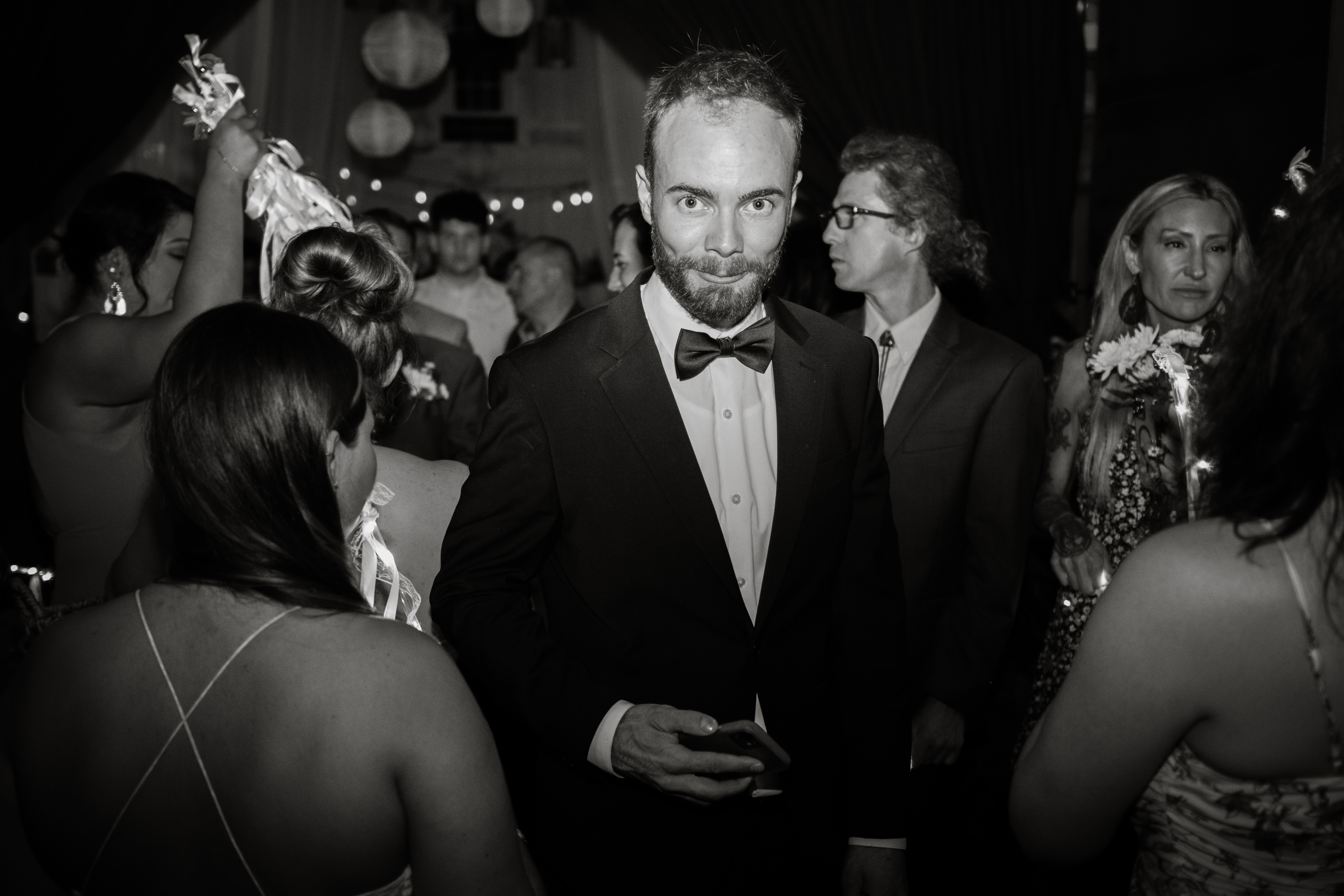 Man in a tuxedo looks at the camera at a formal event